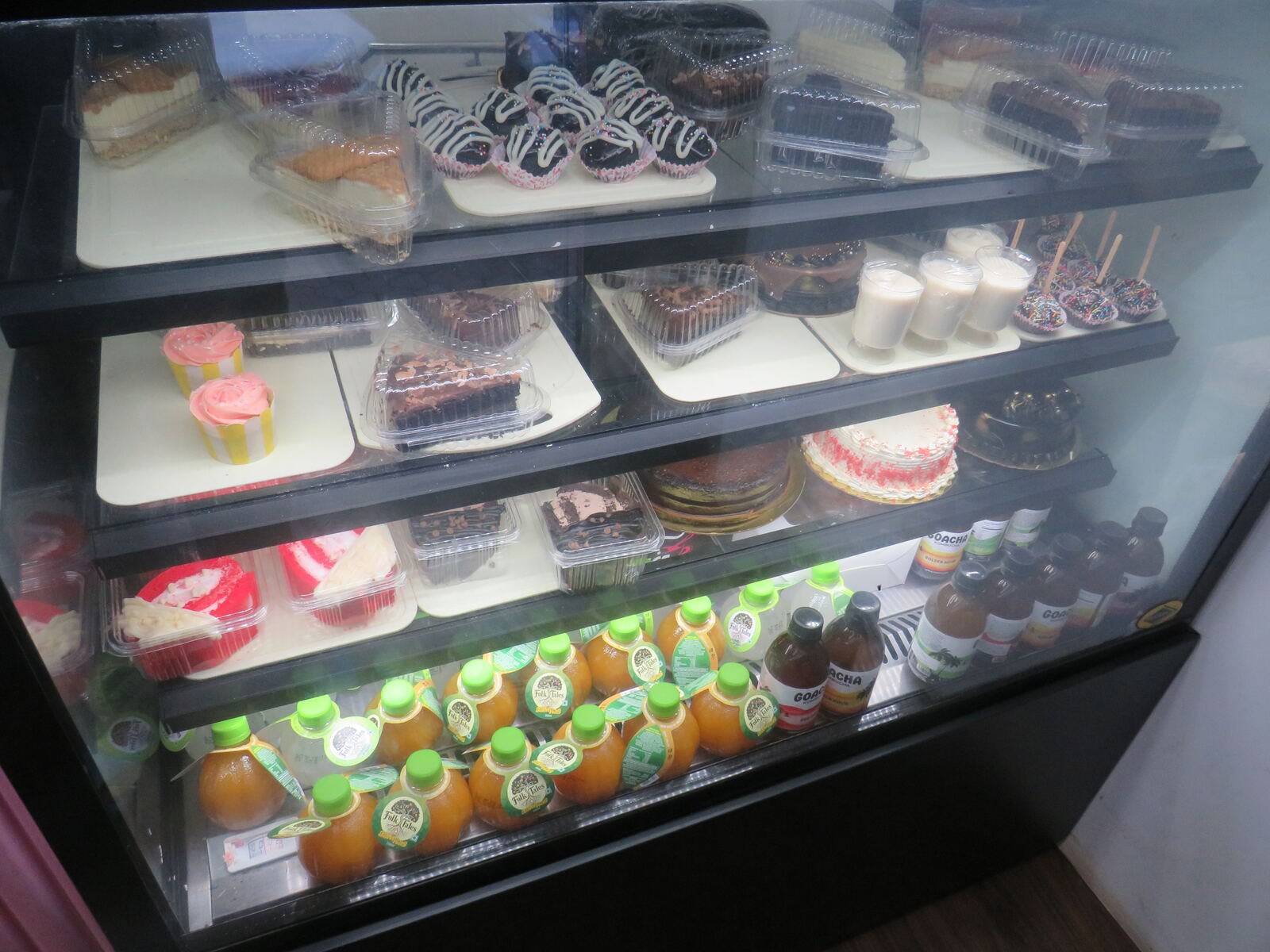 Fresh artisan birthday cakes and celebratory designs displayed inside Nesbakes Bakery Panjim Goa