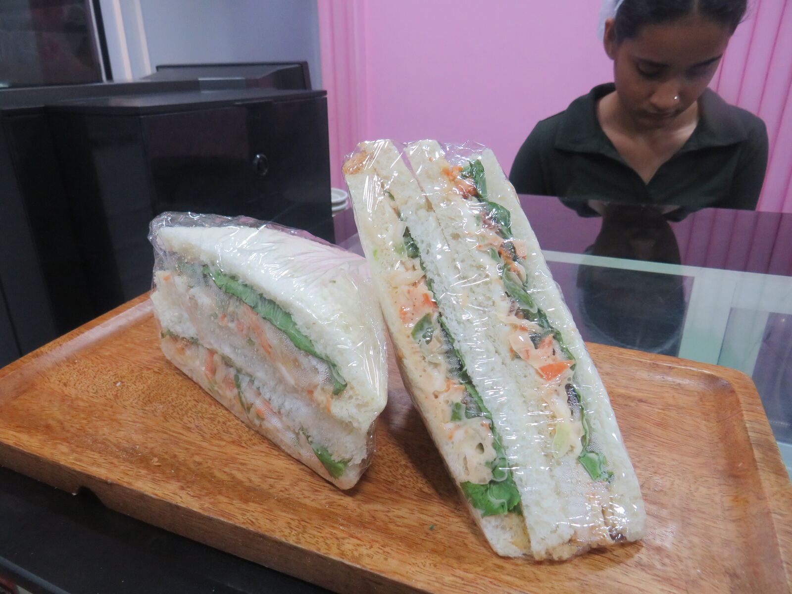 Fresh sandwiches with lettuce, carrot slaw and mayonnaise, sliced and wrapped